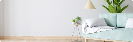 Minimalist corner with plant and wooden stool