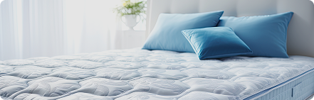 Blue pillows on white bedding